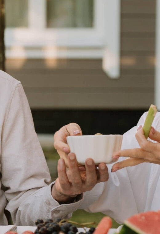 older couple sat together eating and drinking