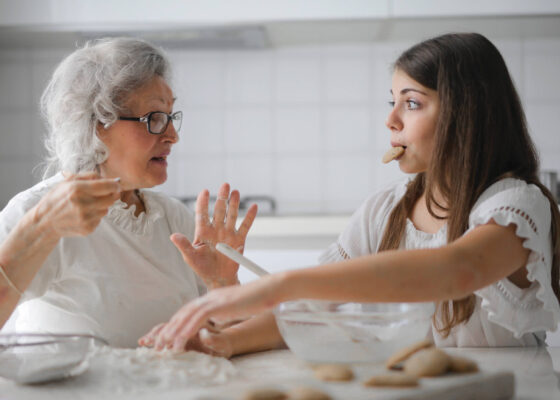 an younger and older woman preparing food together