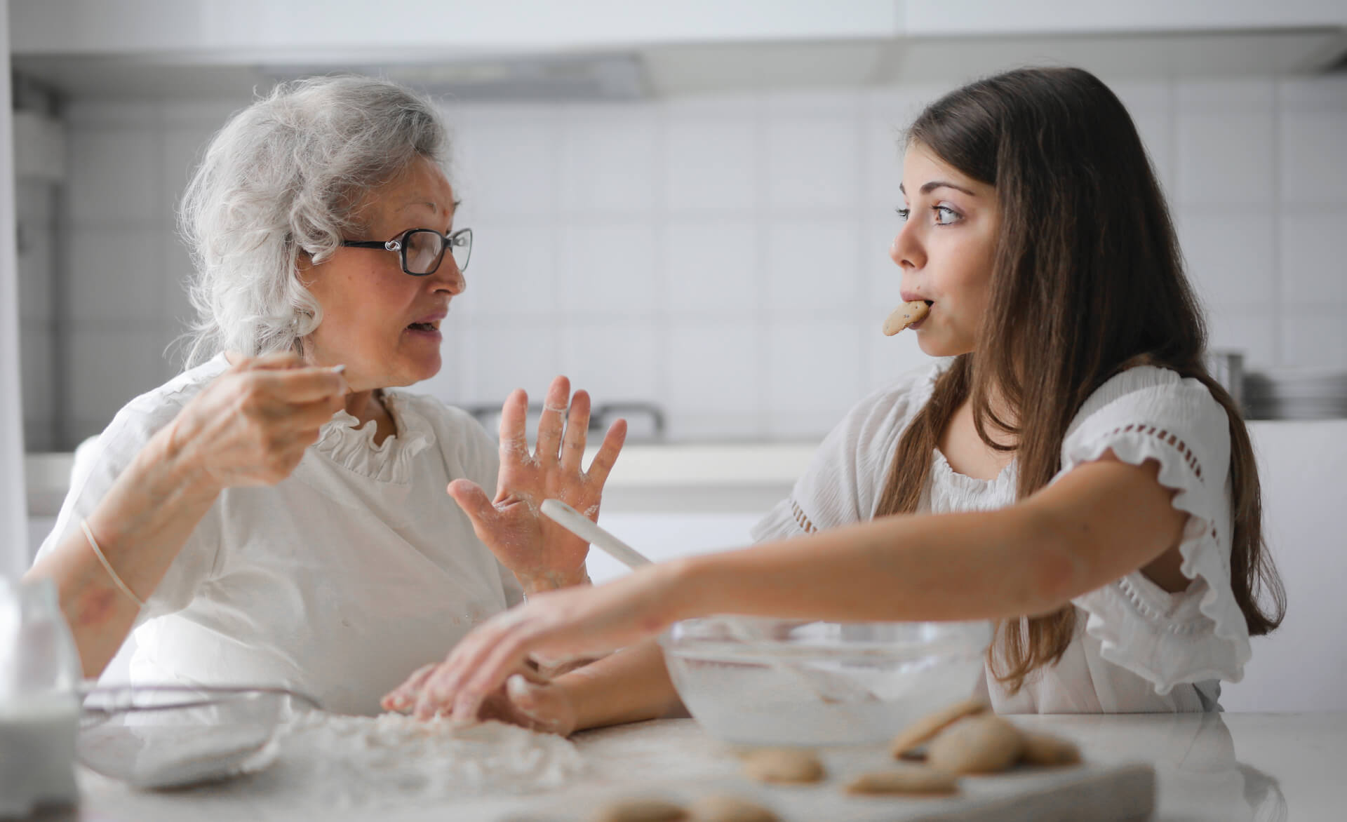 an younger and older woman preparing food together