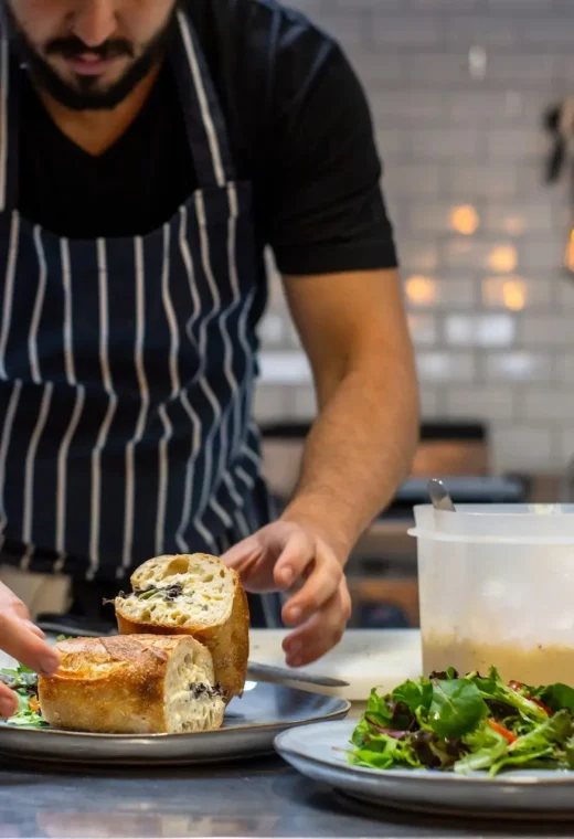 a caterer preparing food putting it on plates