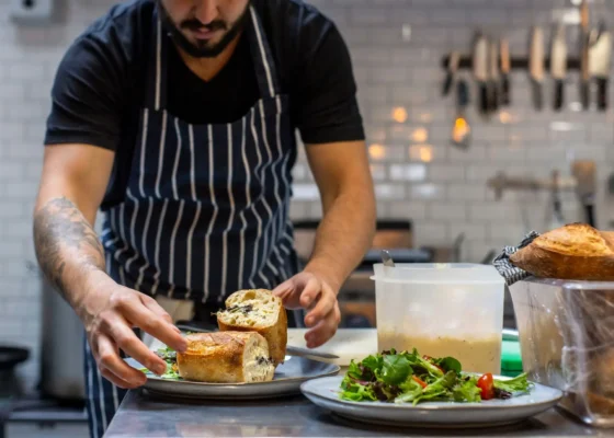 a caterer preparing food putting it on plates