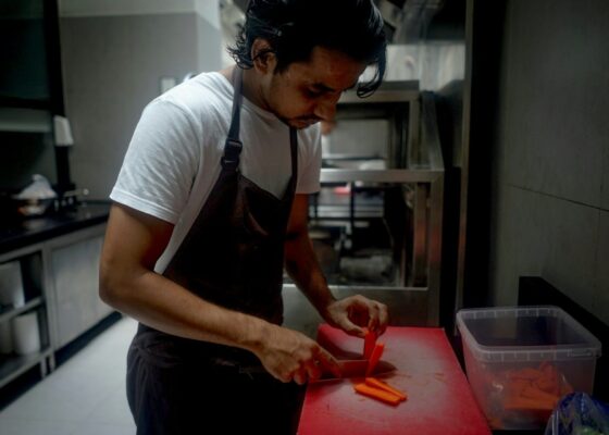 a chef chopping food for care home residents stressing the importance of catering in care homes