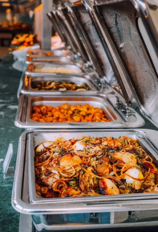 Row of trays with food in them.