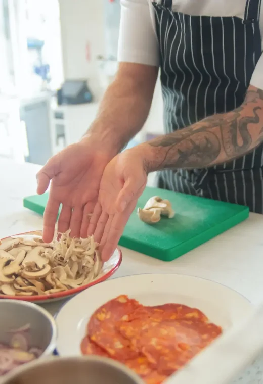 a person preparing food on a kitchen surface, separating different ingredients into different bowls