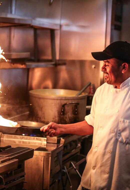image of a chef cooking with fire in a frying pan