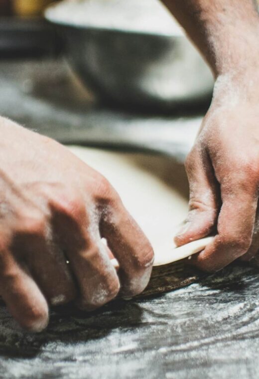 a chef pressing dough learning how to become a successful chef