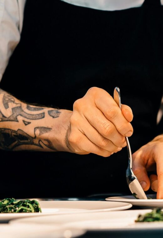 image of a chef plating up food in a kitchen