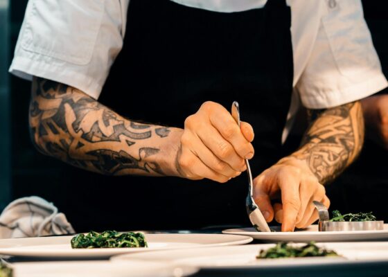 image of a chef plating up food in a kitchen