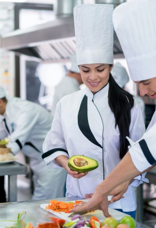Chefs preparing food in a kitchen showing a chef staffing agency vs recruitment agency